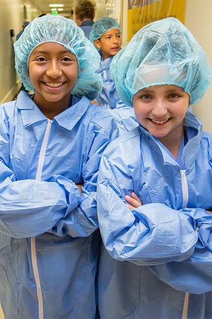 Birney Elementary students Emily Ramirez and Leanna Martinez wear surgical “bunny suits” to enter the sterile operating room.
