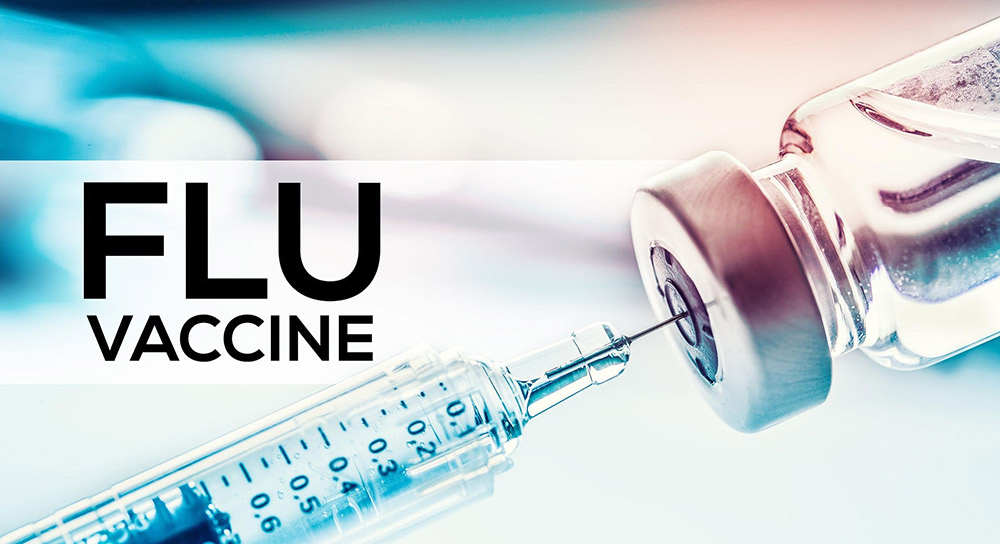 Graphic reading "Flu Vaccine" showing a needle going into a vial