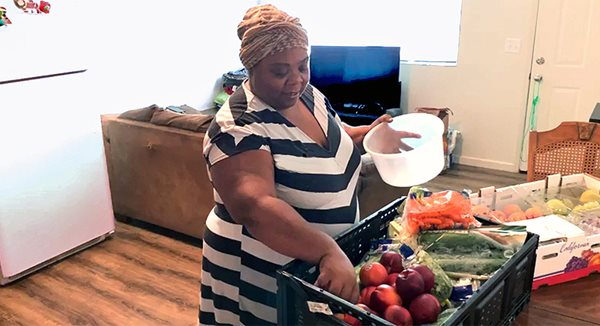 A woman dishes up food in her home