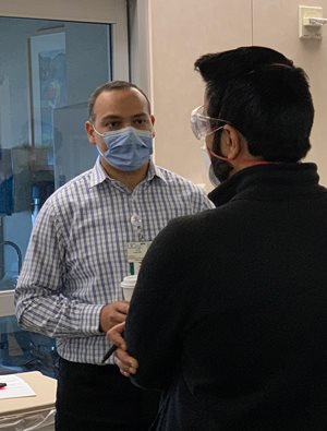 Dr. Mohamed Fayed speaks with a colleague
