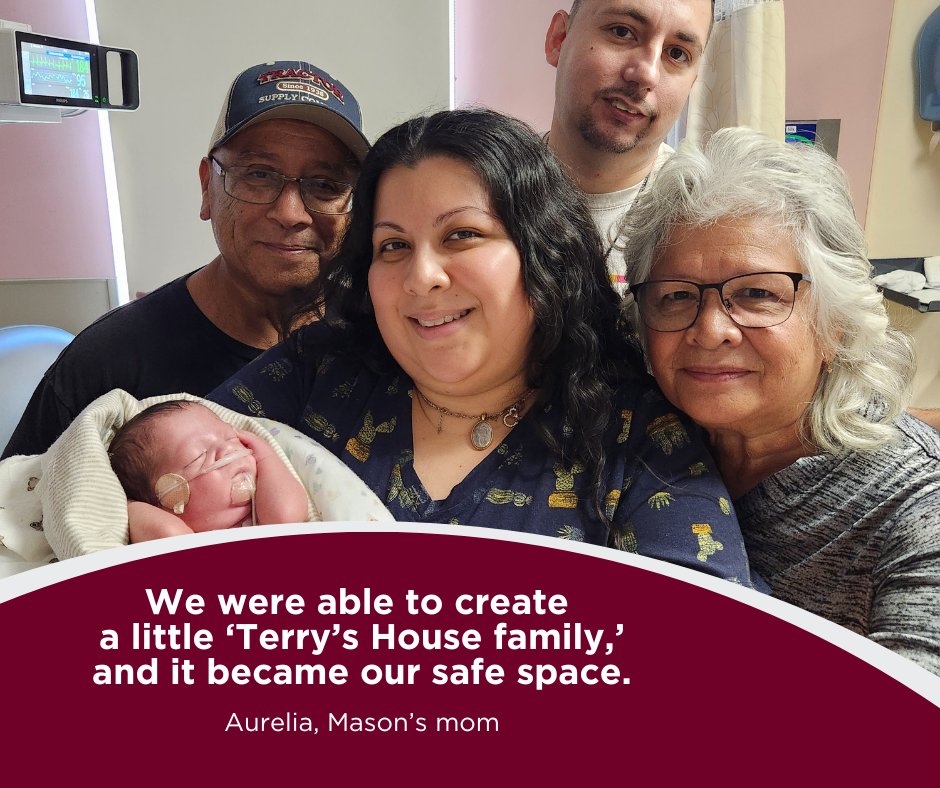 Four adults and a newborn are seen inside a hospital room.