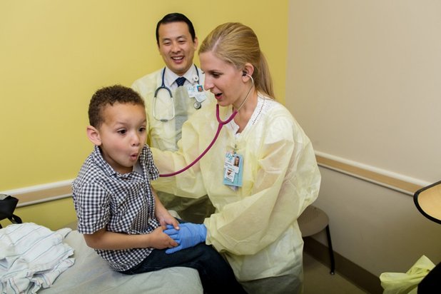 UCSF pediatric resident Dr. Nicole Barbera gets her patient Dominic Bledsaw to take a deep breath during a visit to the cystic fibrosis clinic at Community Regional while UCSF faculty member Dr. John Moua observes.